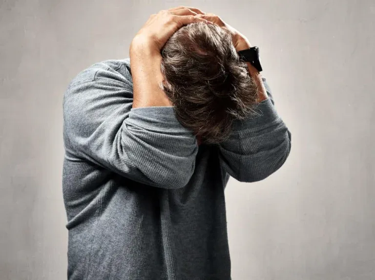 postpartum-depression-in-men anxious man in Idaho holding his head, facing postpartum depression