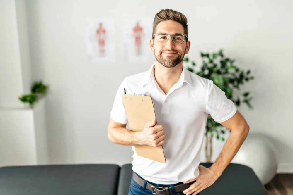 Man in Idaho pinching bridge of nose, anxious at laptop feeling stressed