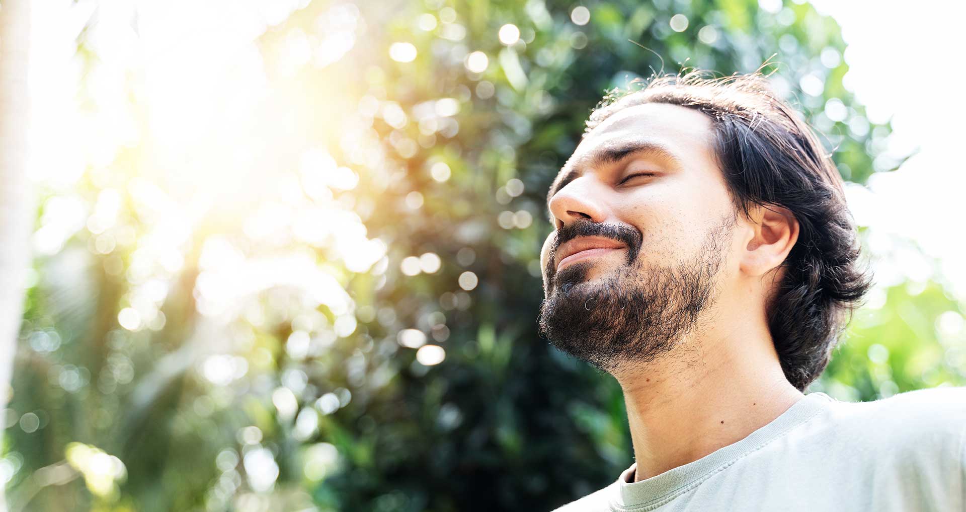 Young man relaxing without marijuana in sunlit forested area