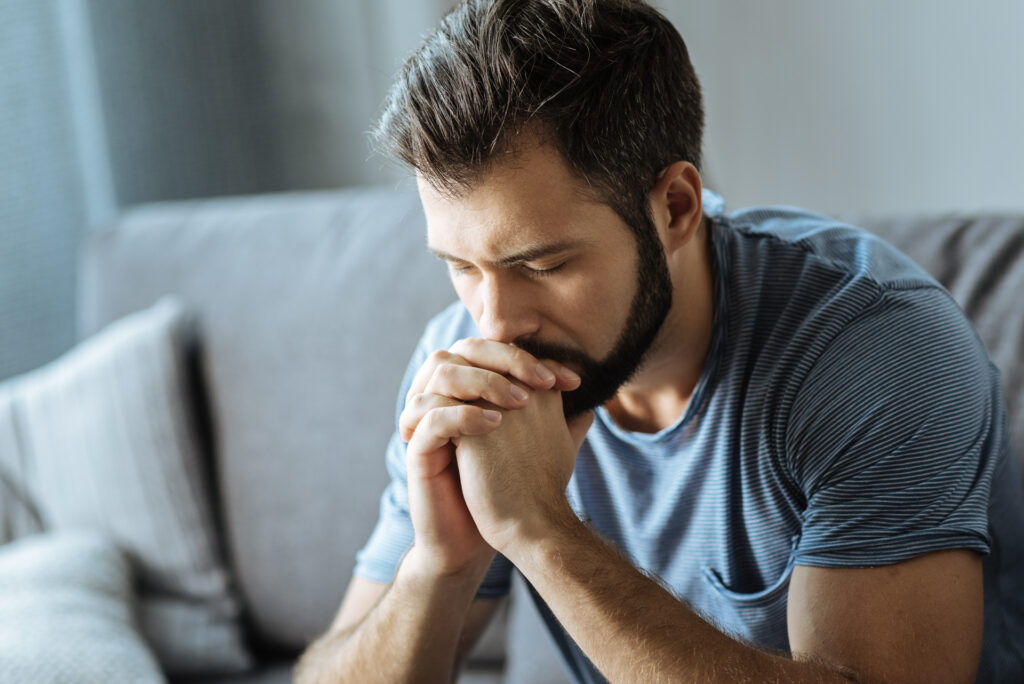 Man contemplating how long he should stay taking methadone for addiction.