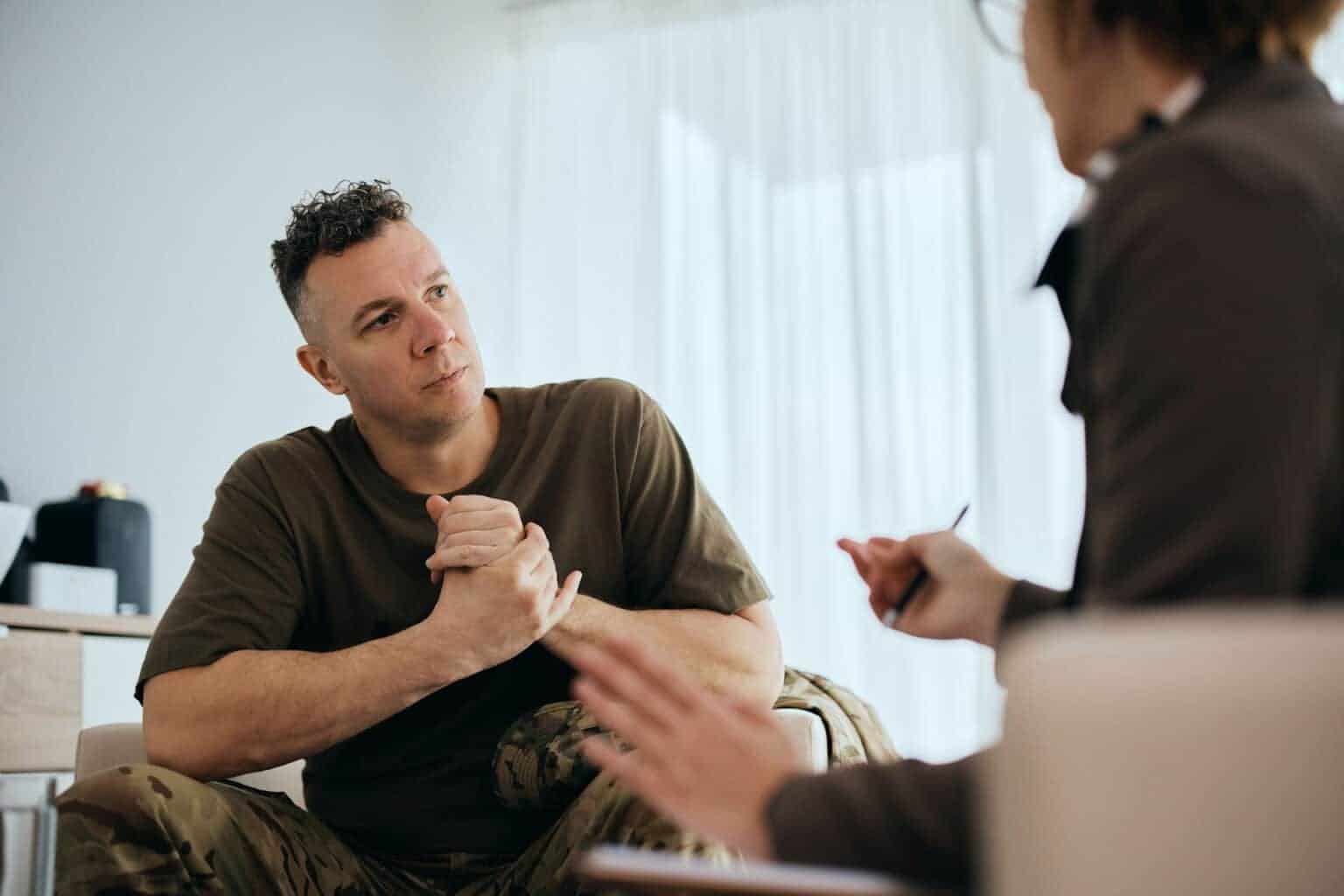 Tall man receiving advice from therapist about caffeine addiction