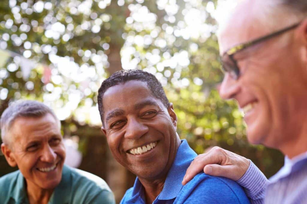 Older men in cheerful conversation about coping mechanisms