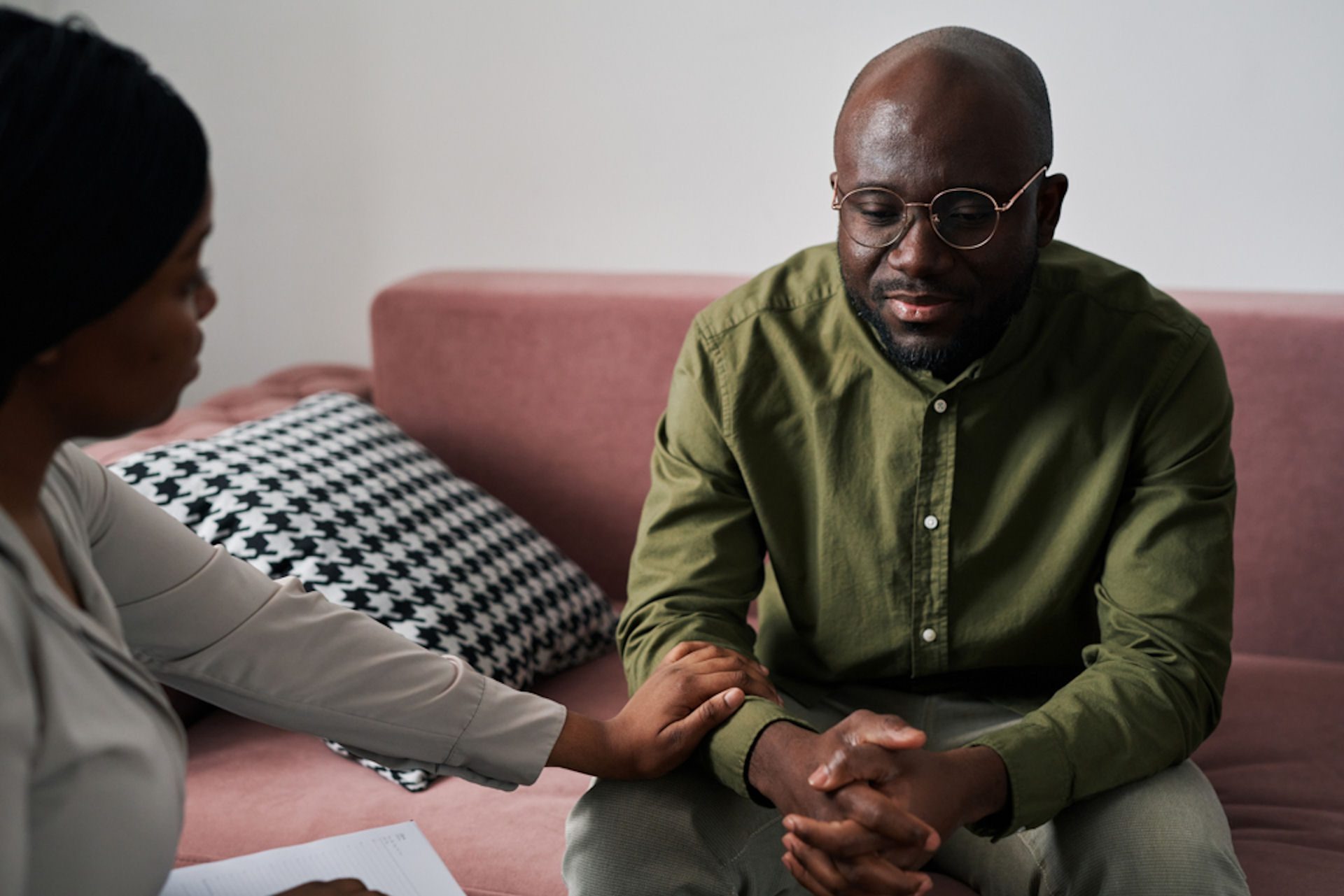 Therapist supporting a man showing distress, discussing drug poisoning symptoms during a counseling session