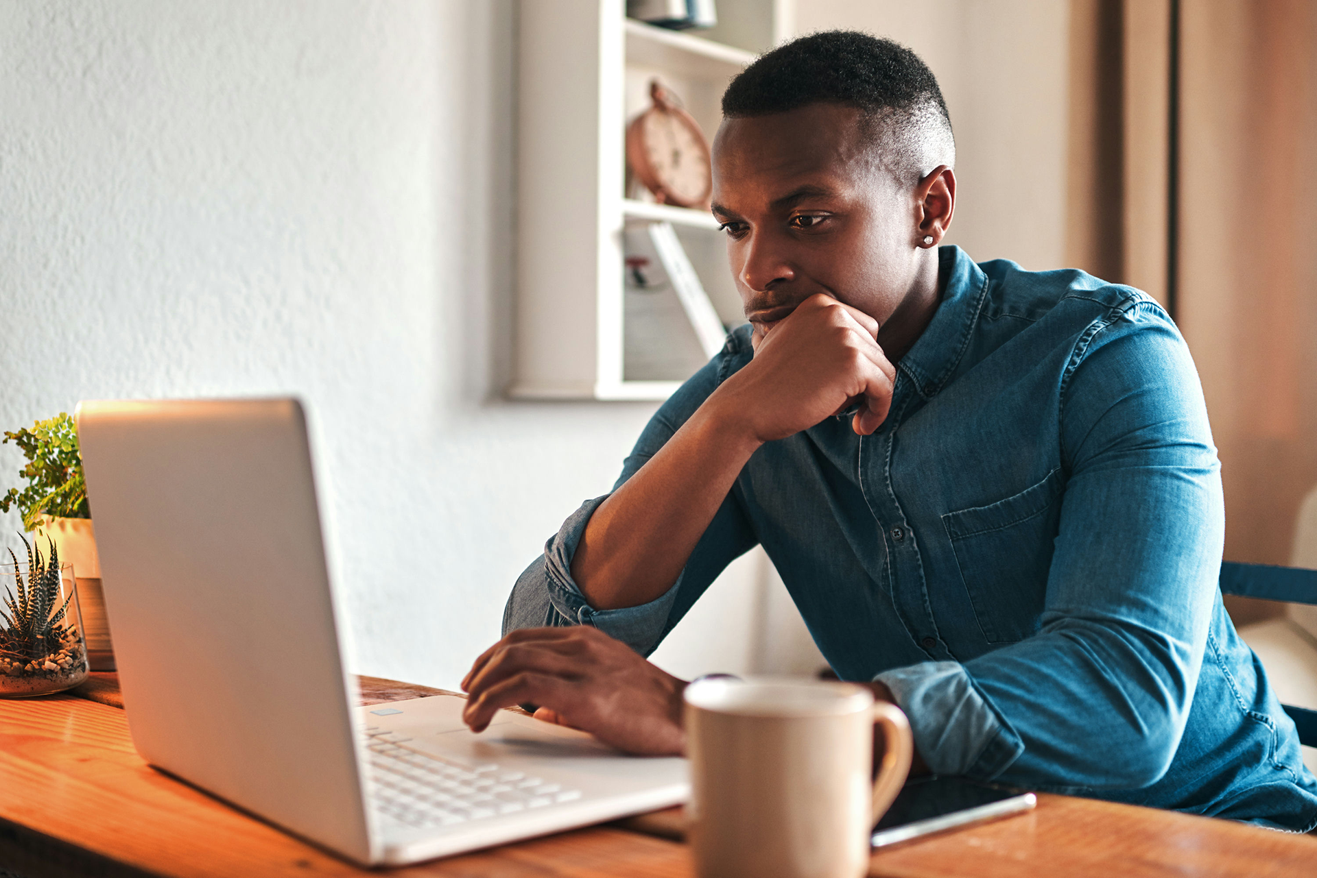 Man researches alcohol and gambling addiction on a laptop.
