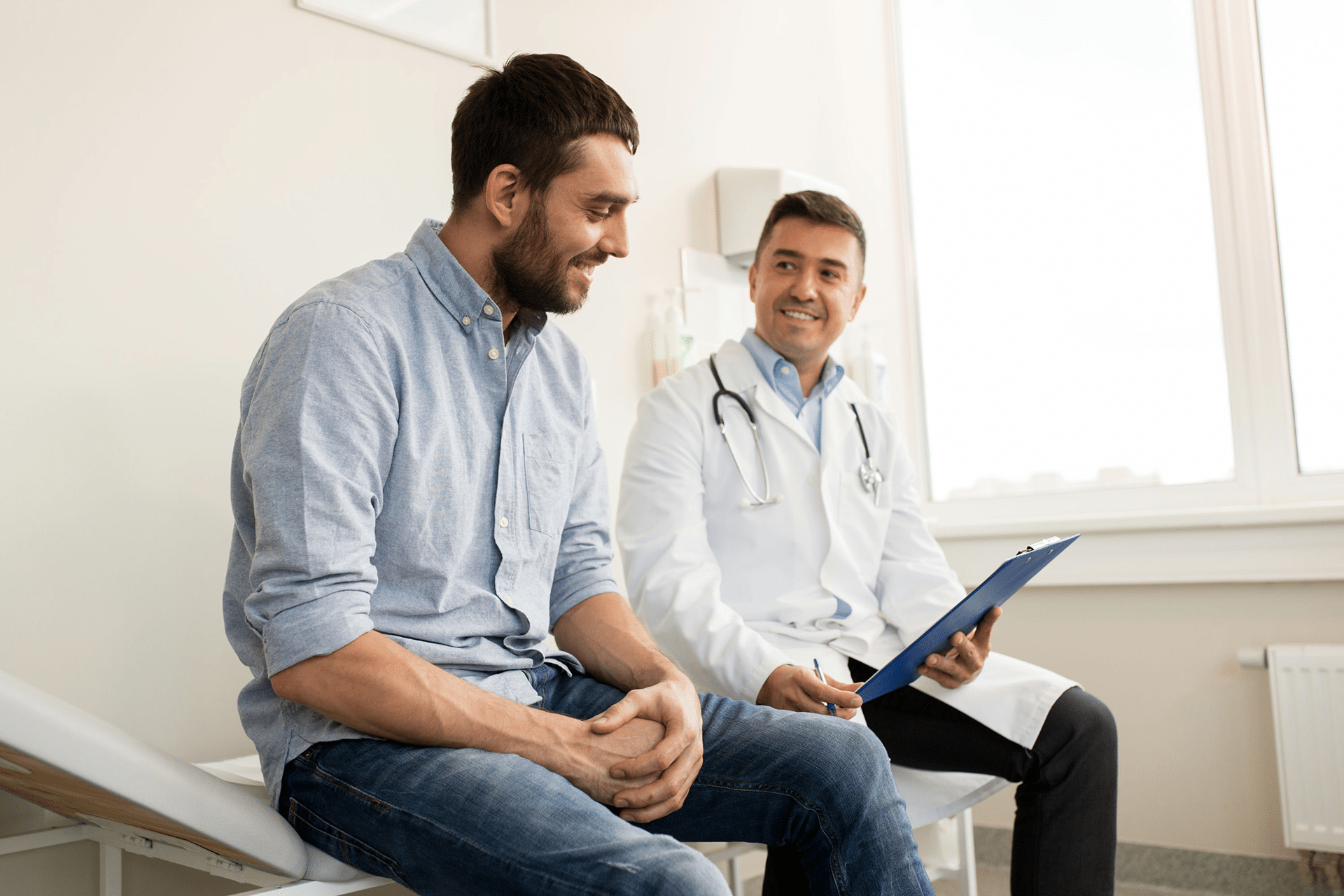 Man discussing doctor shopping with doctor in white coat while both sit on bench.