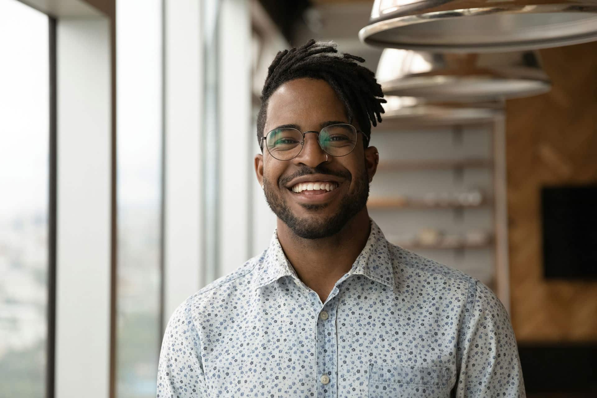 Man smiling in lit living room clean from spring cleaning.