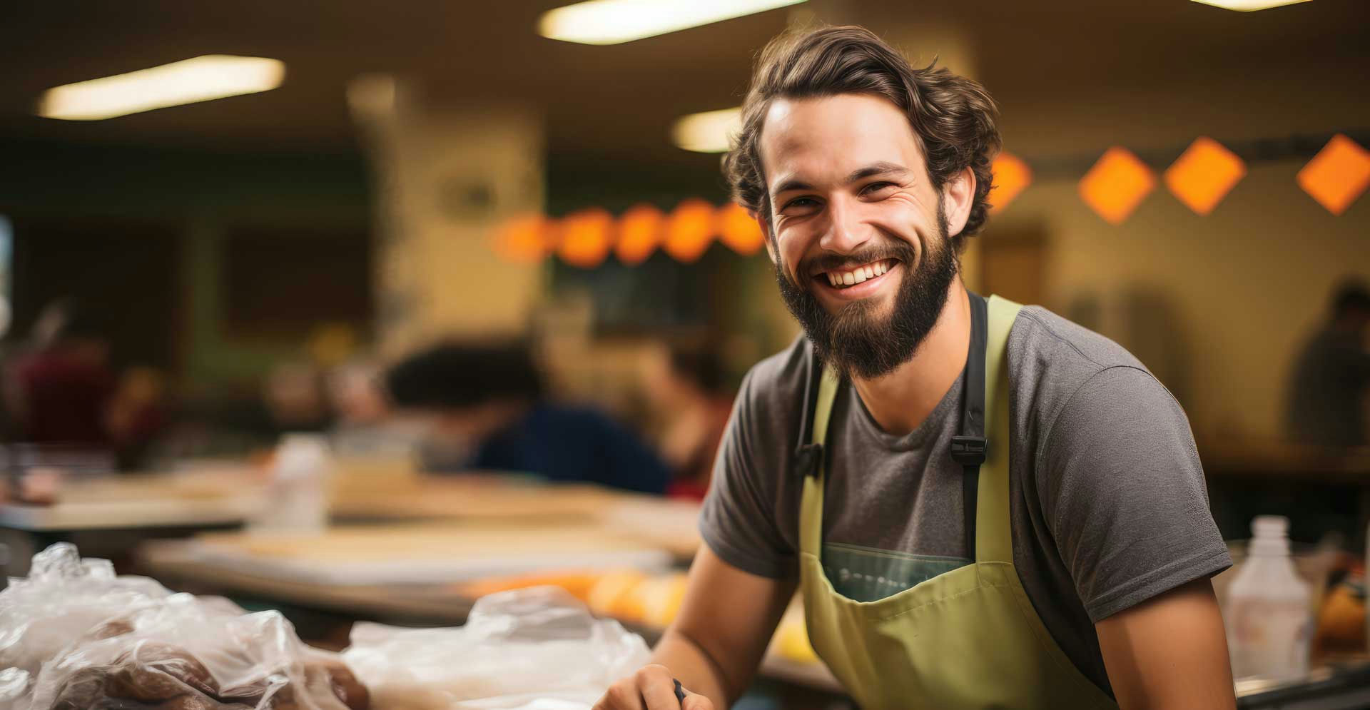 Man smiling in wood shop in rehab for behavioral addiction.