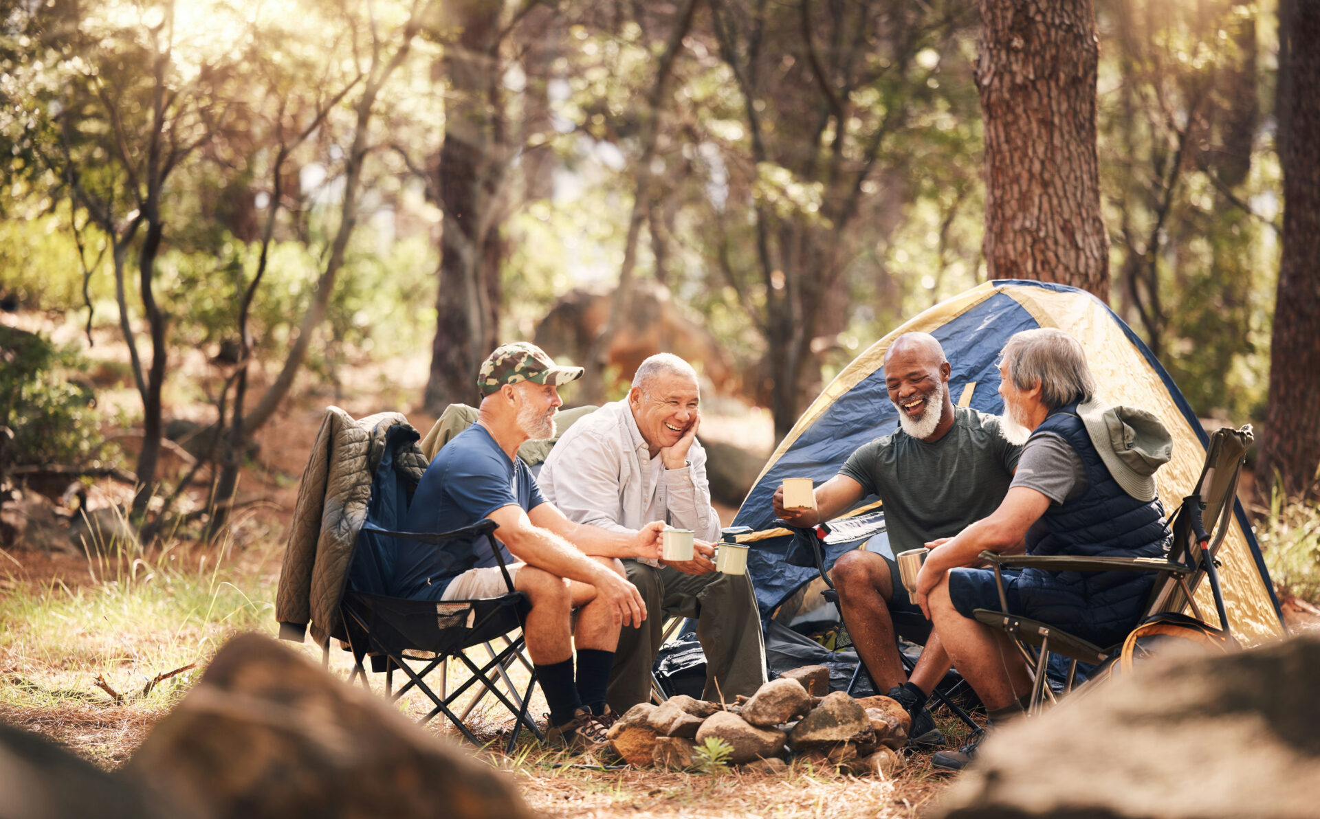 Group of four men on a camping trip supporting friend with job loss depression.