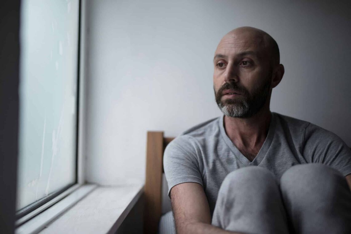 Divorced man sitting while at a mental health appointment.