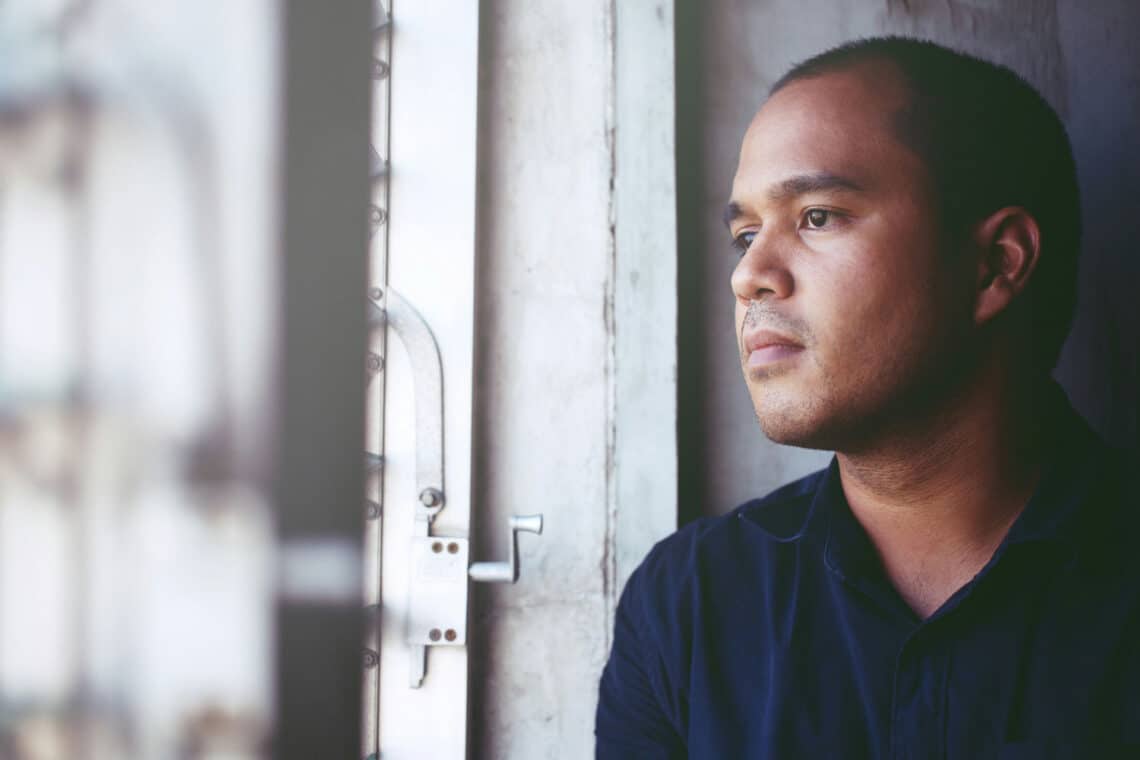 Man looks out window after EMDR bilateral stimulation.