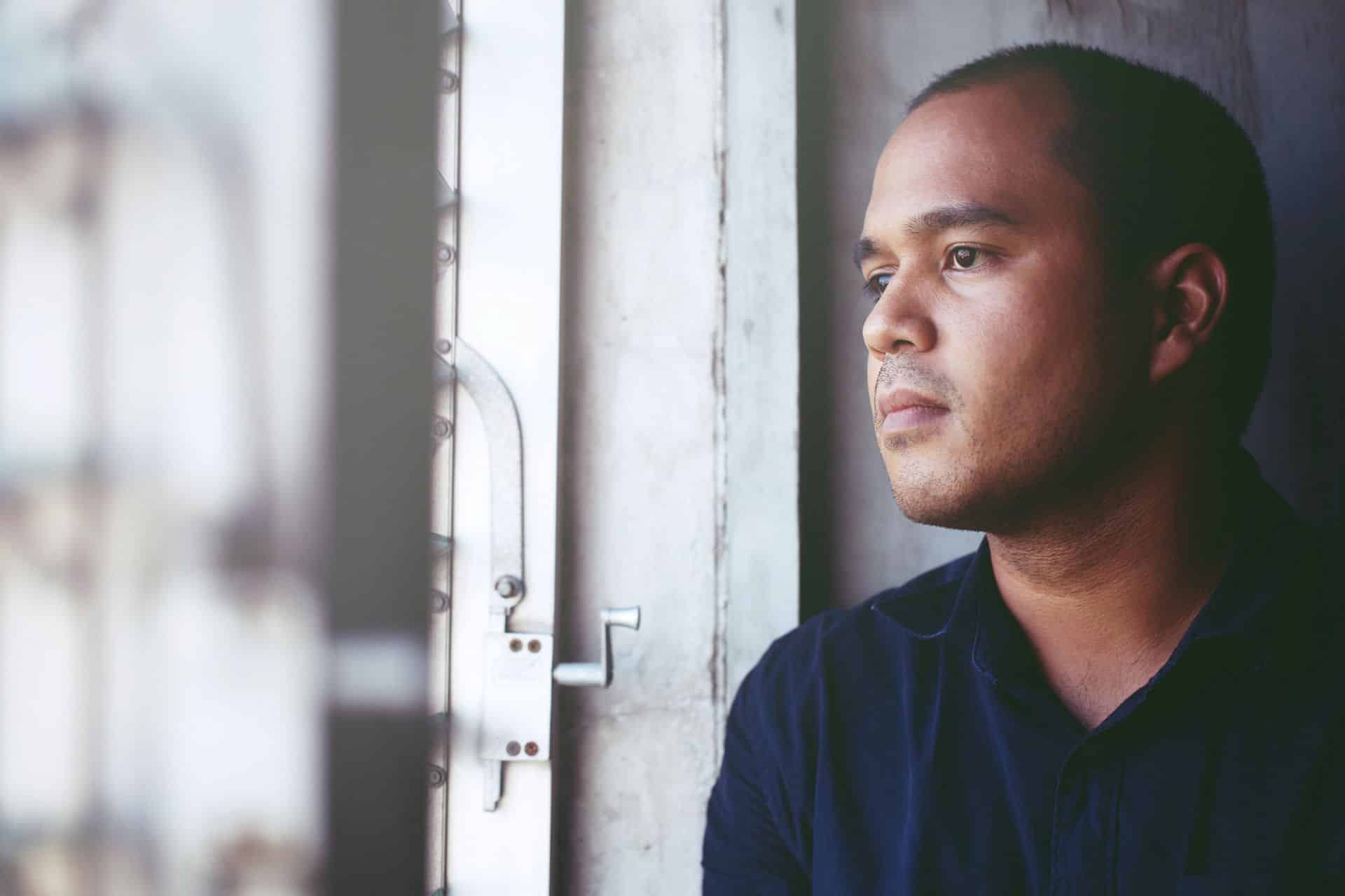 Man looks out window after EMDR bilateral stimulation.